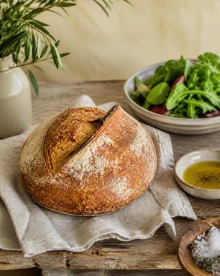Freshly baked sourdough bread with salad and olive oil